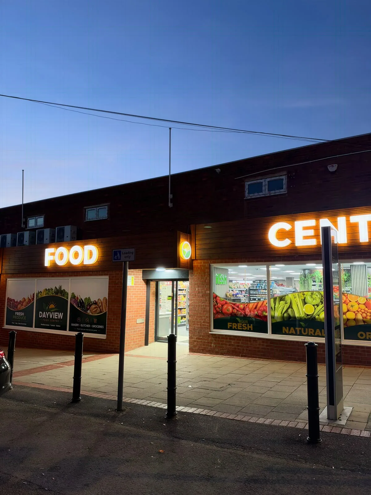 The illuminated Day View shop entrance at Black Swan Yard in Andover